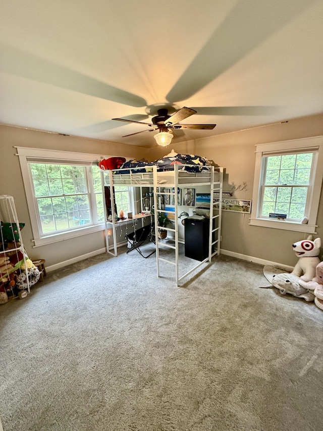 2176 Deepwoods Dr, Gaylord, MI 49735 - carpeted bedroom with multiple windows and ceiling fan