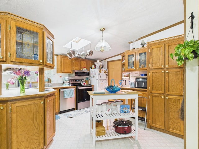 2651 Chipmunk Trl, Grayling, MI 49738 - kitchen featuring stainless steel appliances, light countertops, brown cabinets, ornamental molding, and glass insert cabinets