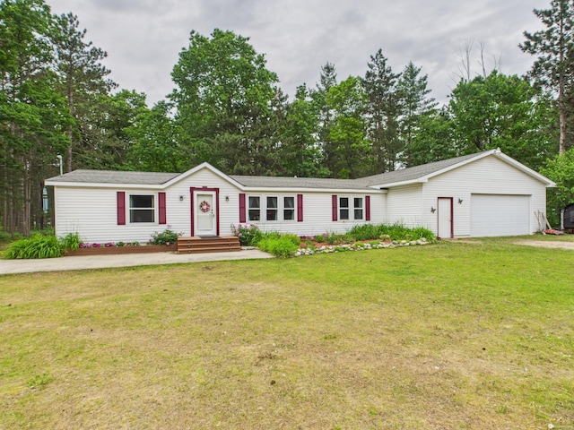 2651 Chipmunk Trl, Grayling, MI 49738 - view of front of home with a front yard, view of scattered trees, a garage, and driveway