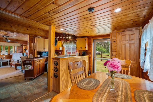 1960 Highbank Trl, Lewiston, MI 49756 - dining area with wood ceiling, wooden walls, ceiling fan, and dark flooring
