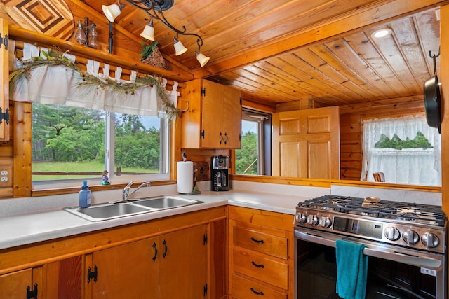 1960 Highbank Trl, Lewiston, MI 49756 - kitchen featuring stainless steel range with gas stovetop, wooden ceiling, light countertops, wood walls, and brown cabinets