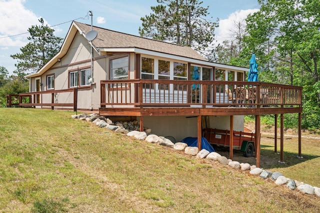 1960 Highbank Trl, Lewiston, MI 49756 - rear view of house with a wooden deck, a shingled roof, and a yard