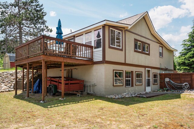 1960 Highbank Trl, Lewiston, MI 49756 - back of house featuring a wooden deck, a storage unit, and a shingled roof