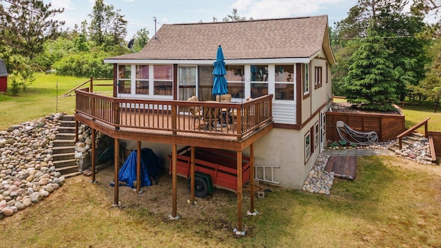 1960 Highbank Trl, Lewiston, MI 49756 - rear view of house with a sunroom, a shingled roof, a wooden deck, and a lawn