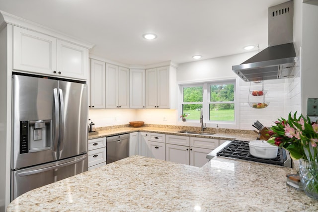 9660 Richardson Rd, Cheboygan, MI 49721 - kitchen with appliances with stainless steel finishes, wall chimney exhaust hood, white cabinets, light stone counters, and recessed lighting
