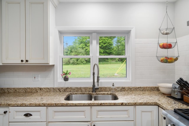 9660 Richardson Rd, Cheboygan, MI 49721 - kitchen featuring white cabinets, stove, light stone counters, and backsplash