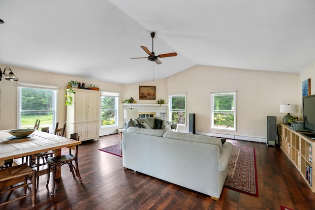 9660 Richardson Rd, Cheboygan, MI 49721 - living area featuring baseboard heating, a ceiling fan, vaulted ceiling, a fireplace, and dark wood-type flooring