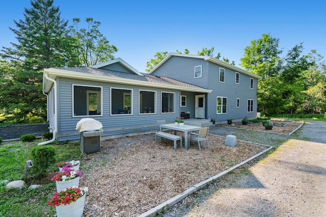 9660 Richardson Rd, Cheboygan, MI 49721 - rear view of house featuring roof with shingles and outdoor dining area
