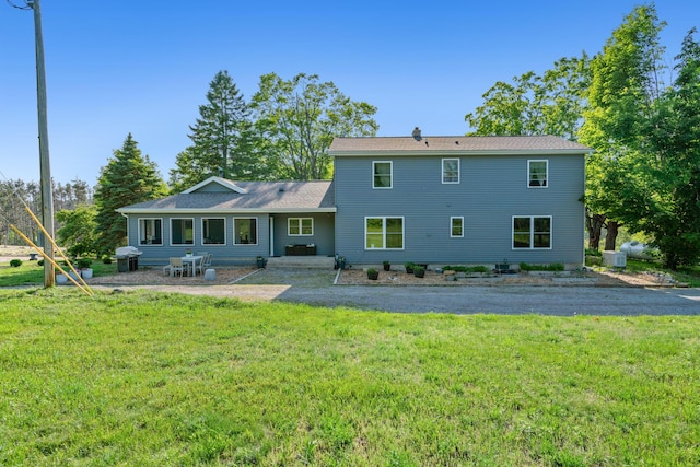9660 Richardson Rd, Cheboygan, MI 49721 - rear view of property with a patio area and a lawn