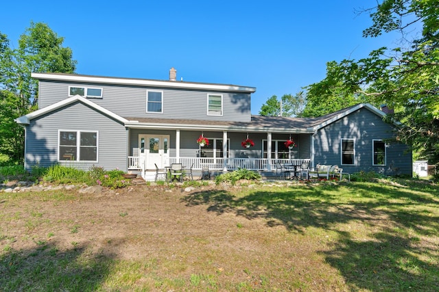 9660 Richardson Rd, Cheboygan, MI 49721 - rear view of house with a yard, a porch, and a chimney