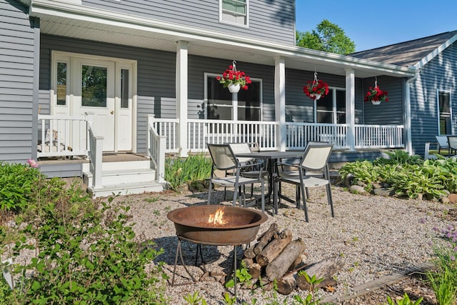 9660 Richardson Rd, Cheboygan, MI 49721 - porch with a fire pit and outdoor dining space
