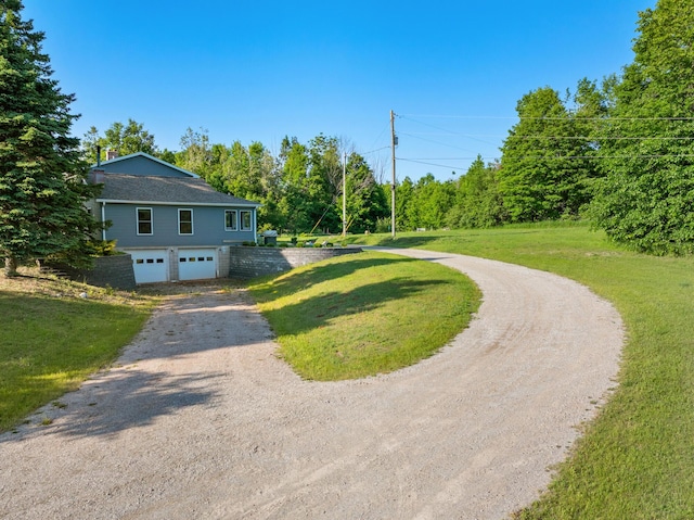 9660 Richardson Rd, Cheboygan, MI 49721 - view of front of house featuring driveway, a garage, and a front lawn