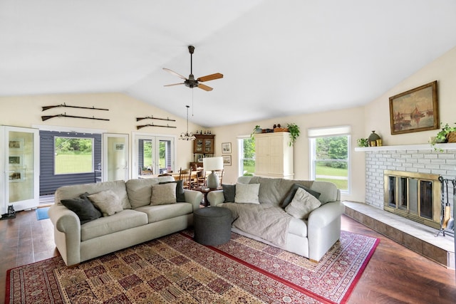 9660 Richardson Rd, Cheboygan, MI 49721 - living area with vaulted ceiling, a ceiling fan, dark wood-style flooring, and a brick fireplace