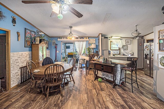6304 Old 27, Vanderbilt, MI 49795 - dining room with ornamental molding, ceiling fan, a textured ceiling, dark wood-style flooring, and vaulted ceiling