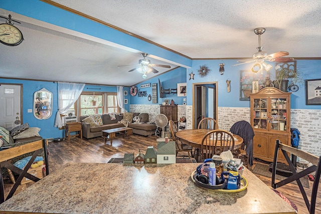 6304 Old 27, Vanderbilt, MI 49795 - dining room featuring ceiling fan, a textured ceiling, crown molding, wood finished floors, and lofted ceiling