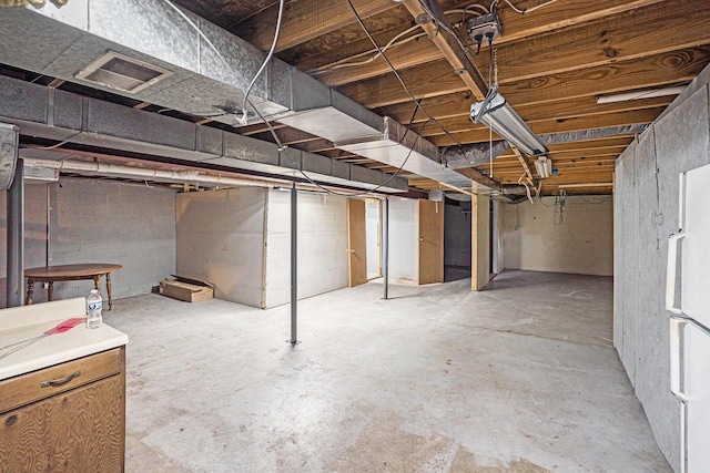 6304 Old 27, Vanderbilt, MI 49795 - unfinished basement with freestanding refrigerator