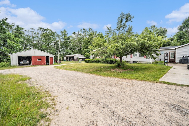 6304 Old 27, Vanderbilt, MI 49795 - exterior space with a detached garage, an outbuilding, and dirt driveway