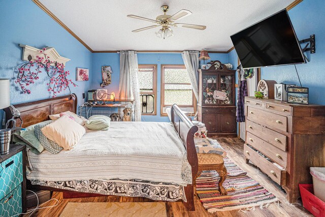 6304 Old 27, Vanderbilt, MI 49795 - bedroom with crown molding, light wood finished floors, lofted ceiling, a textured ceiling, and a ceiling fan