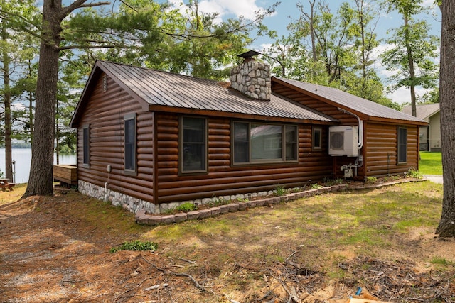 2061 Dreamers Ln, Lewiston, MI 49756 - chalet / cabin featuring a chimney, a metal roof, and log veneer siding