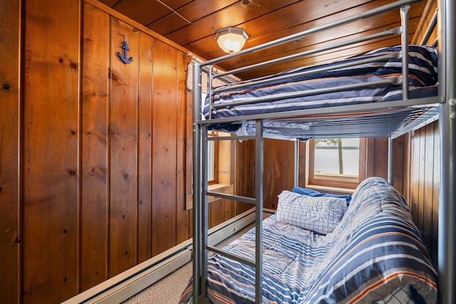 2061 Dreamers Ln, Lewiston, MI 49756 - carpeted bedroom featuring wood walls, baseboard heating, and wooden ceiling