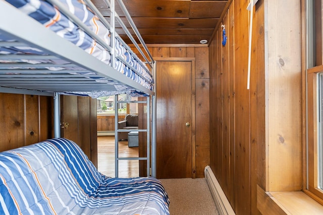 2061 Dreamers Ln, Lewiston, MI 49756 - bedroom featuring wooden walls, a baseboard radiator, and wooden ceiling