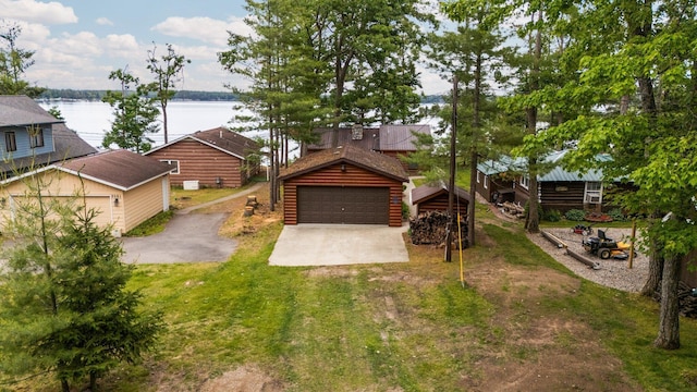 2061 Dreamers Ln, Lewiston, MI 49756 - view of front of property featuring a detached garage and a water view