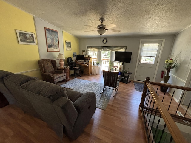 10604 Adams St, Ossineke, MI 49766 - living area with wood finished floors, a ceiling fan, and a textured ceiling