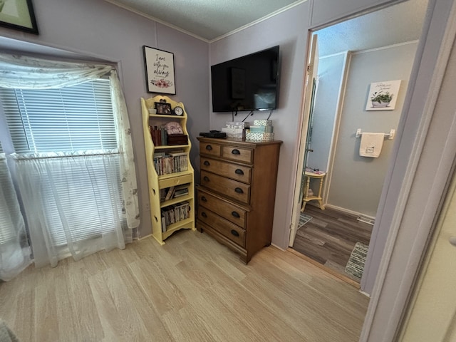 10604 Adams St, Ossineke, MI 49766 - bedroom with light wood-style flooring and crown molding