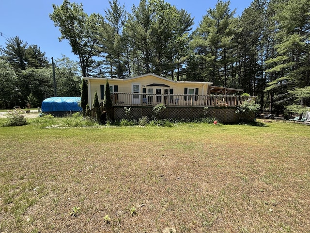 10604 Adams St, Ossineke, MI 49766 - view of front of property featuring a deck and a front yard