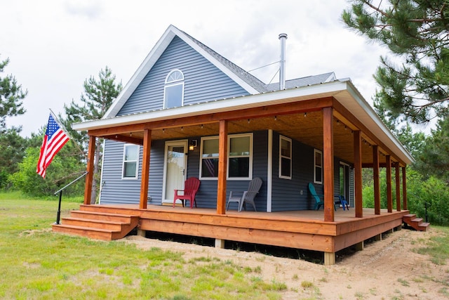 4696 Glacial Field Dr, Elmira, MI 49730 - back of property featuring a porch and a yard