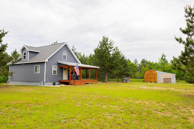 4696 Glacial Field Dr, Elmira, MI 49730 - view of front of house with a storage shed and a front lawn