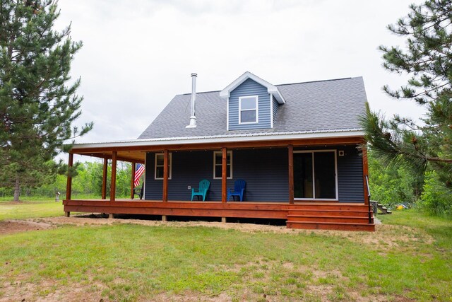 4696 Glacial Field Dr, Elmira, MI 49730 - rear view of house featuring a yard
