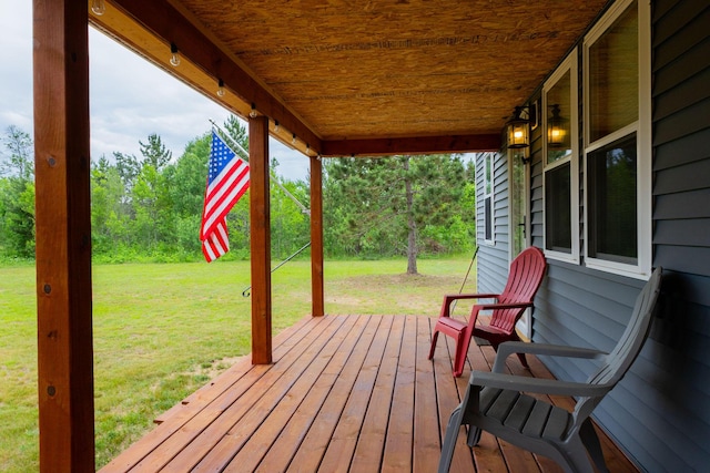 4696 Glacial Field Dr, Elmira, MI 49730 - wooden deck with a lawn