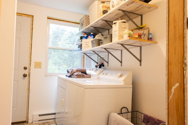 4696 Glacial Field Dr, Elmira, MI 49730 - laundry area with baseboard heating, washing machine and dryer, and healthy amount of natural light