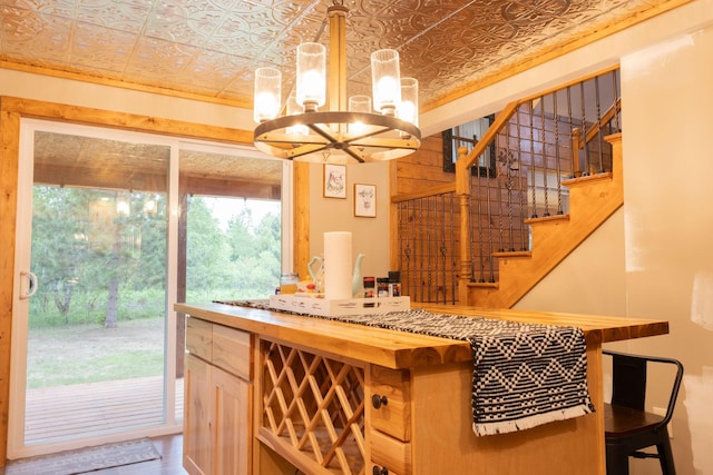 4696 Glacial Field Dr, Elmira, MI 49730 - bar featuring an ornate ceiling, a chandelier, stairway, and decorative light fixtures