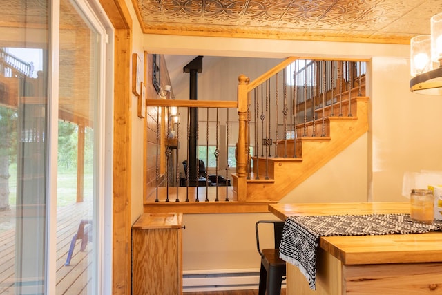 4696 Glacial Field Dr, Elmira, MI 49730 - staircase with an ornate ceiling, baseboard heating, and plenty of natural light