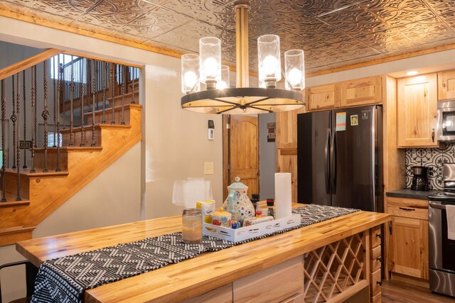 4696 Glacial Field Dr, Elmira, MI 49730 - kitchen featuring wooden counters, an ornate ceiling, a chandelier, stainless steel appliances, and light brown cabinetry