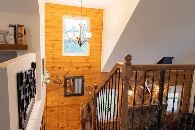 4696 Glacial Field Dr, Elmira, MI 49730 - stairway with wooden walls and a chandelier