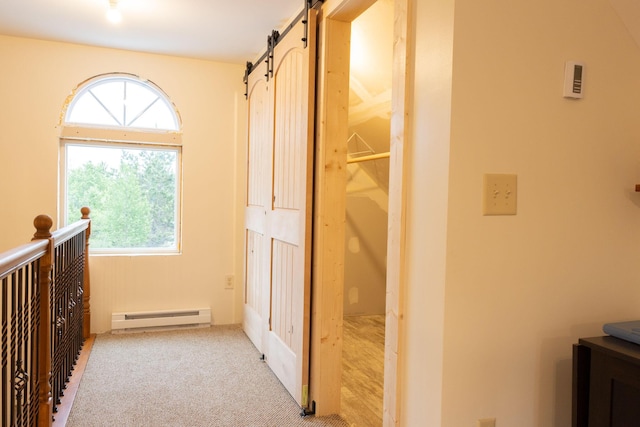 4696 Glacial Field Dr, Elmira, MI 49730 - corridor with a baseboard heating unit, a barn door, and light colored carpet