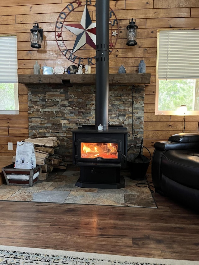4696 Glacial Field Dr, Elmira, MI 49730 - detailed view of wood walls, a wood stove, and wood finished floors
