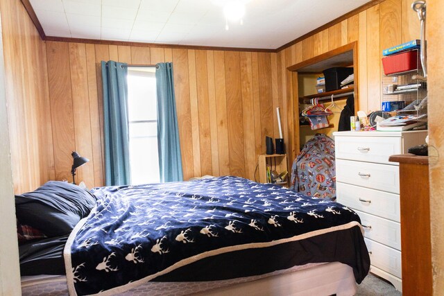 210 N Maple St, Mancelona, MI 49659 - bedroom featuring wood walls, crown molding, and carpet
