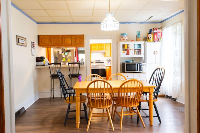 210 N Maple St, Mancelona, MI 49659 - dining area featuring a drop ceiling and dark wood finished floors