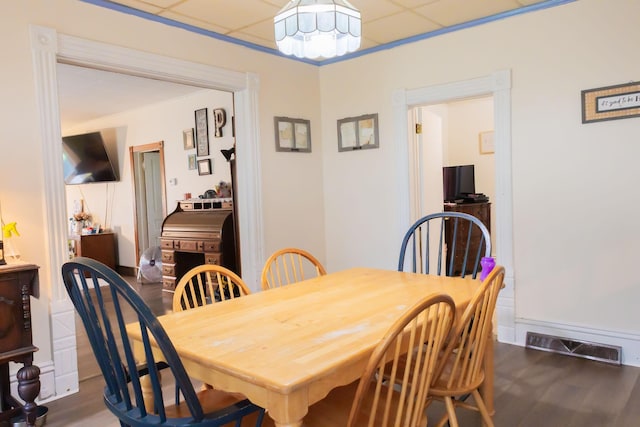 210 N Maple St, Mancelona, MI 49659 - dining area featuring wood finished floors, a drop ceiling, and a chandelier