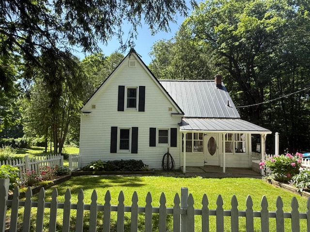 3628 Rau Rd, West Branch, MI 48661 - rear view of property featuring a metal roof, covered porch, and a chimney