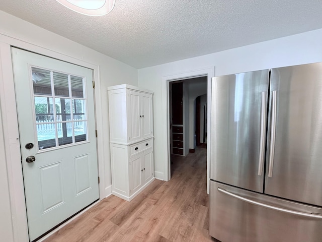 3628 Rau Rd, West Branch, MI 48661 - doorway featuring light wood finished floors and a textured ceiling