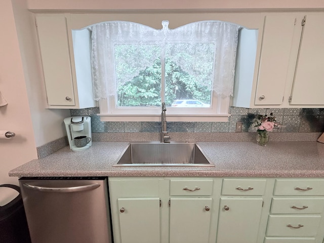 3628 Rau Rd, West Branch, MI 48661 - kitchen featuring stainless steel dishwasher, white cabinetry, and decorative backsplash