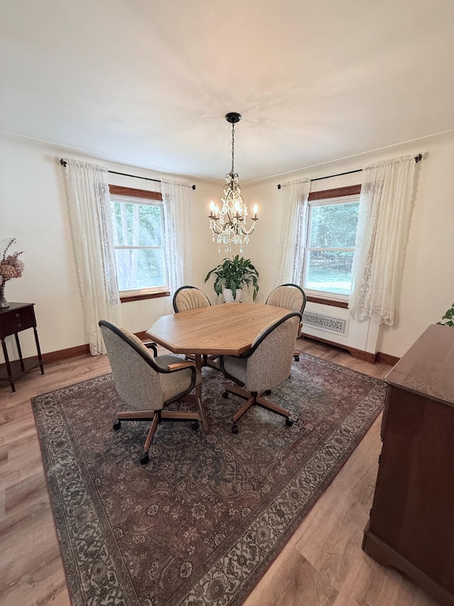 3628 Rau Rd, West Branch, MI 48661 - dining area featuring healthy amount of natural light, a chandelier, and light wood-style flooring