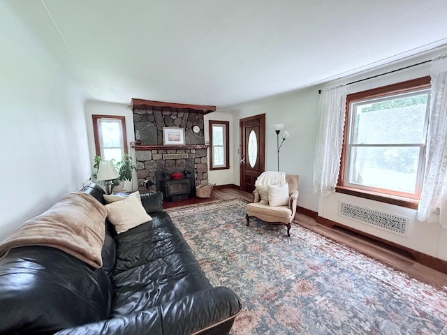 3628 Rau Rd, West Branch, MI 48661 - living area with healthy amount of natural light, wood finished floors, and a wood stove