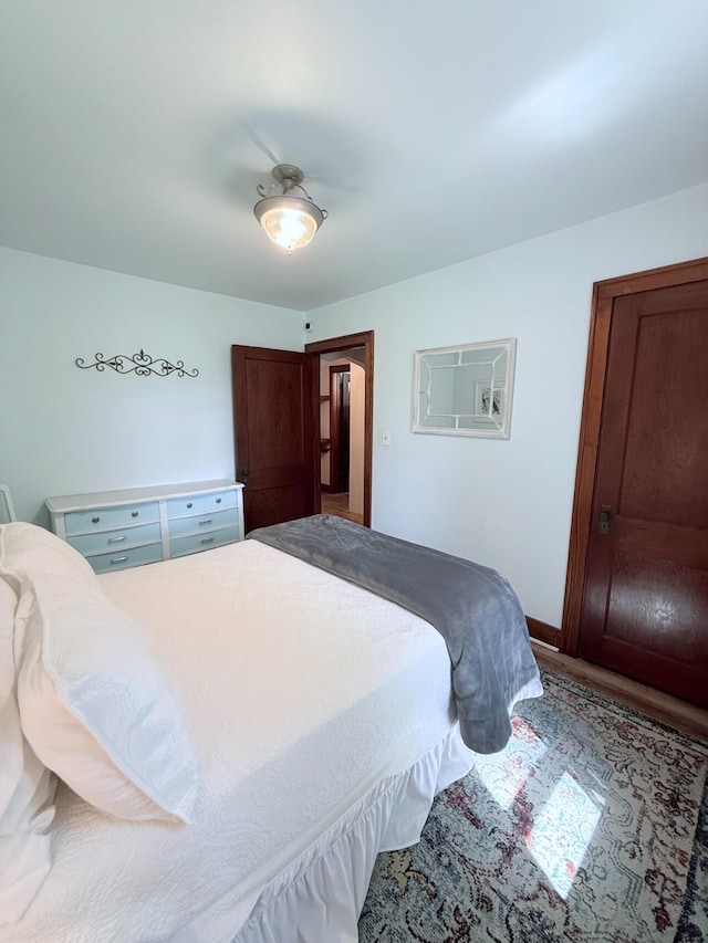 3628 Rau Rd, West Branch, MI 48661 - bedroom featuring baseboards and wood finished floors