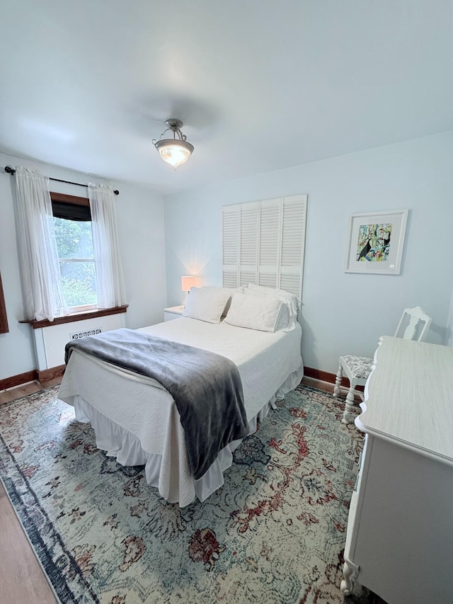 3628 Rau Rd, West Branch, MI 48661 - bedroom featuring baseboards and wood finished floors